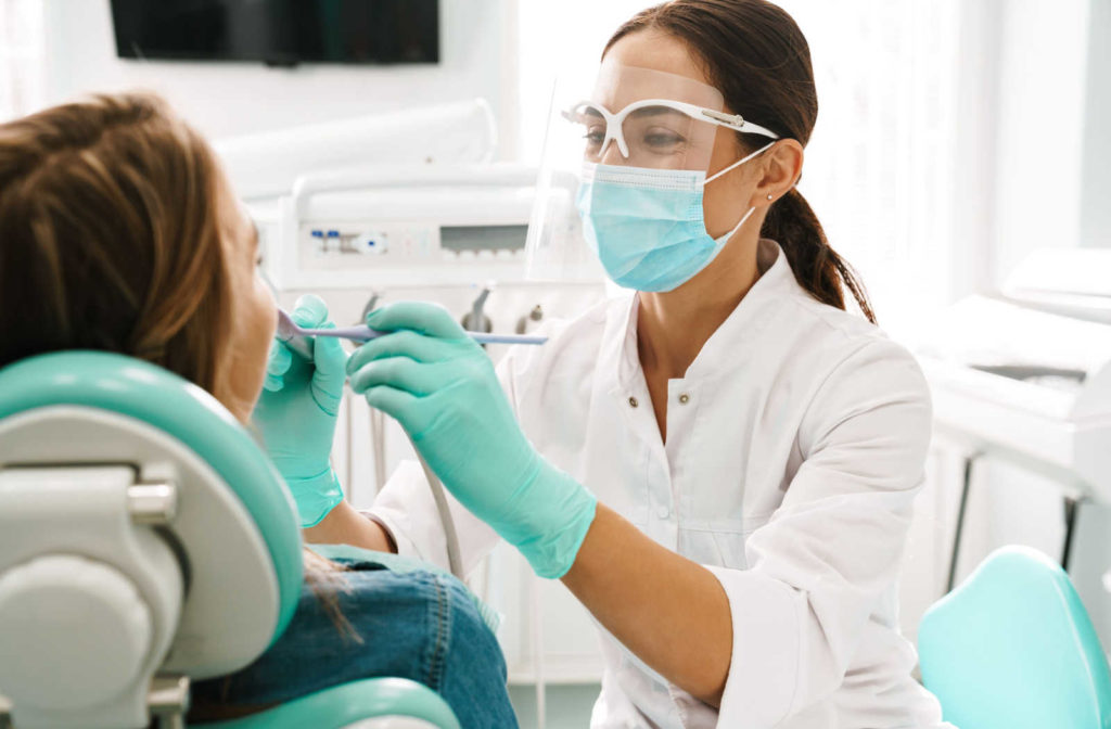 A patient visiting the dentist for a regular exam and cleaning to help preserve their oral health