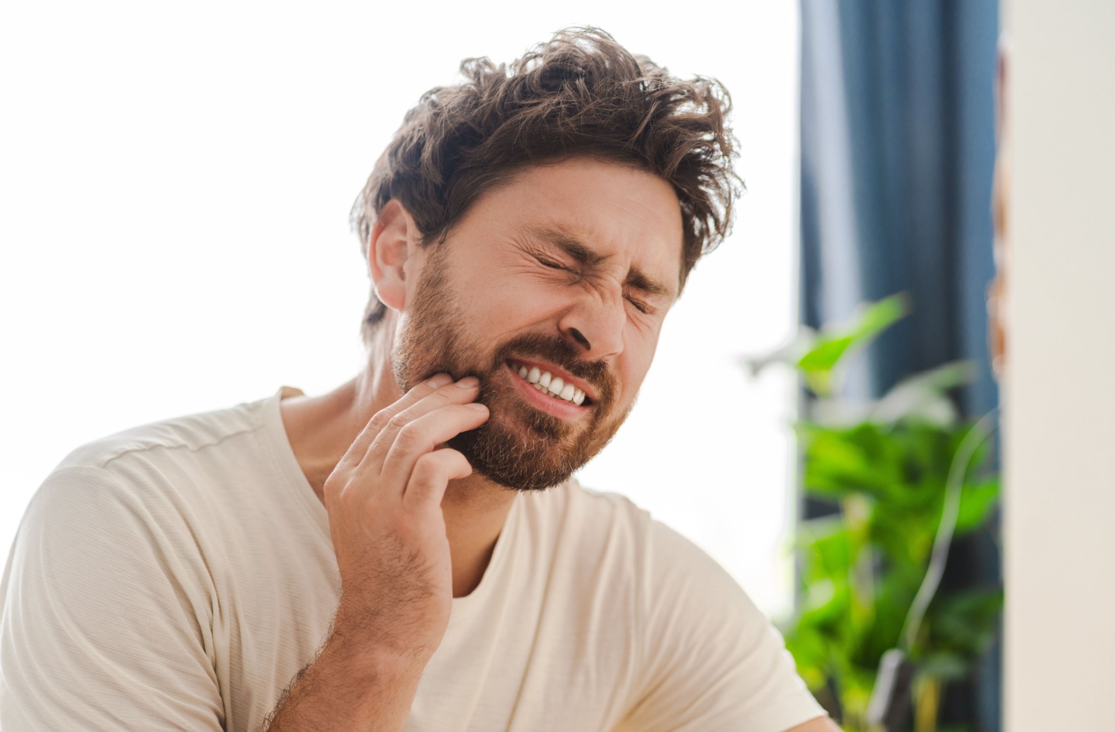 A person brushing their teeth in the morning, maintaining good oral hygiene to prevent tooth decay and keep their smile healthy.